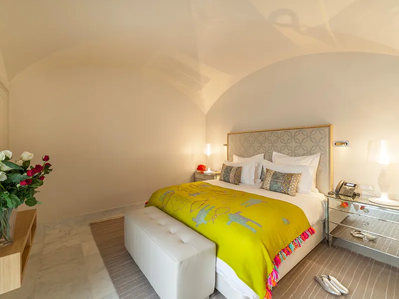 Vaulted Suite bedroom with king size bed and yellow bedspread