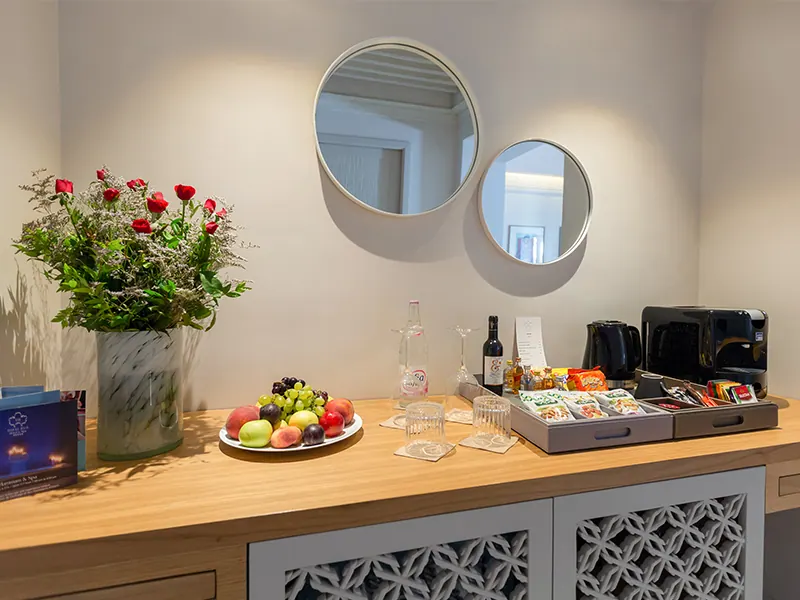 Wooden cabinet with welcome tray, fruit and electric kettle