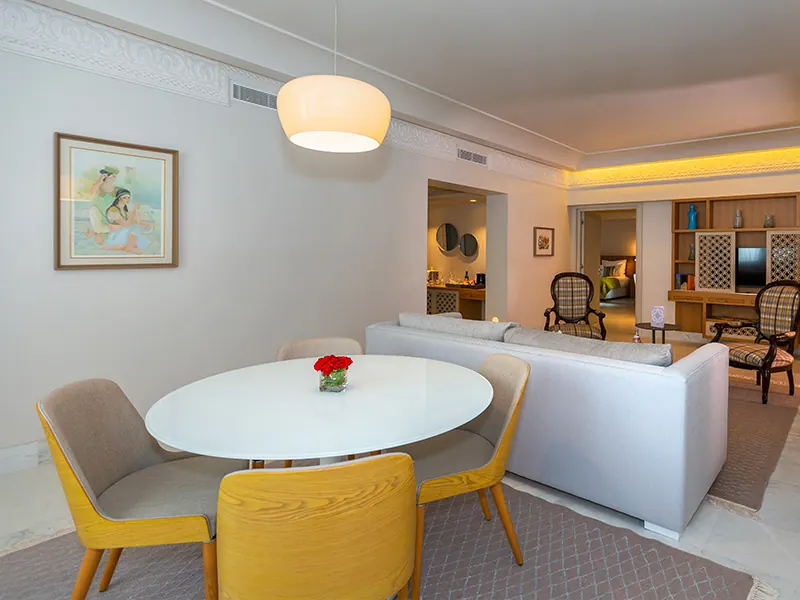 Luxury Suite dining area with round table and open living room