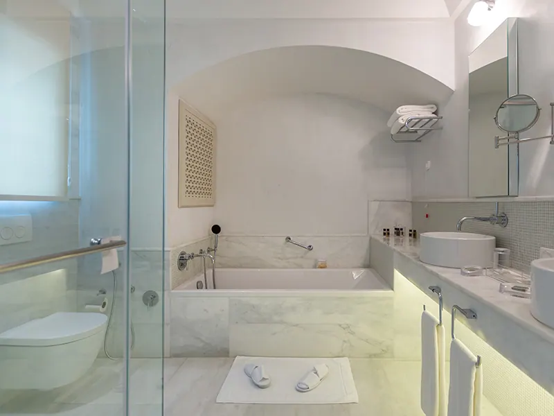 Luxury Suite bathroom with glass shower and marble bathtub