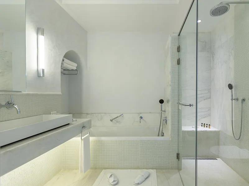 White marble bathroom with glass shower and bathtub